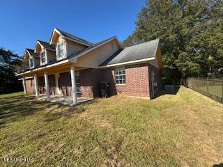 view of side of home featuring a lawn