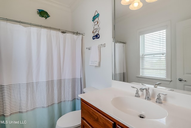 bathroom with a shower with curtain, toilet, vanity, and crown molding