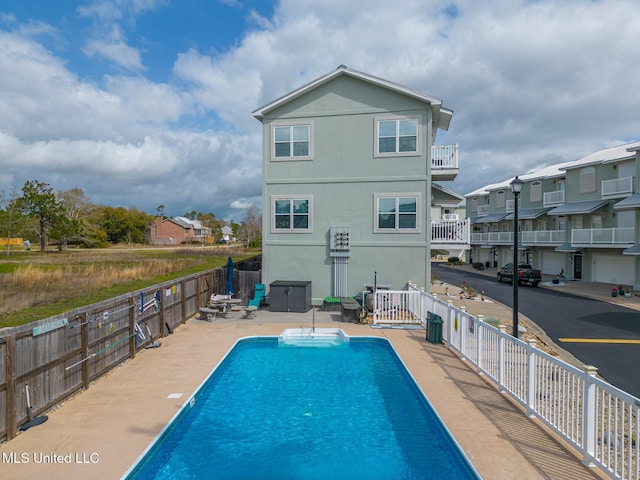 view of pool with a fenced in pool, a residential view, a patio area, and fence