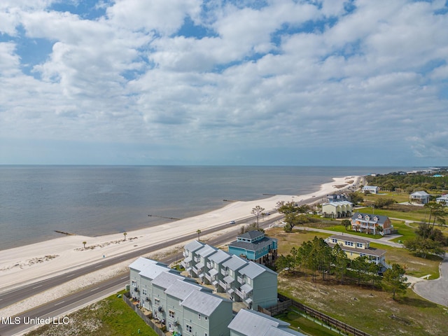 birds eye view of property with a water view and a view of the beach