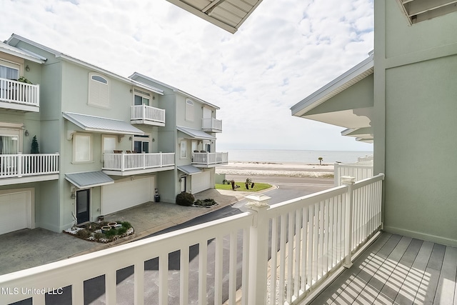 balcony featuring a water view and a view of the beach