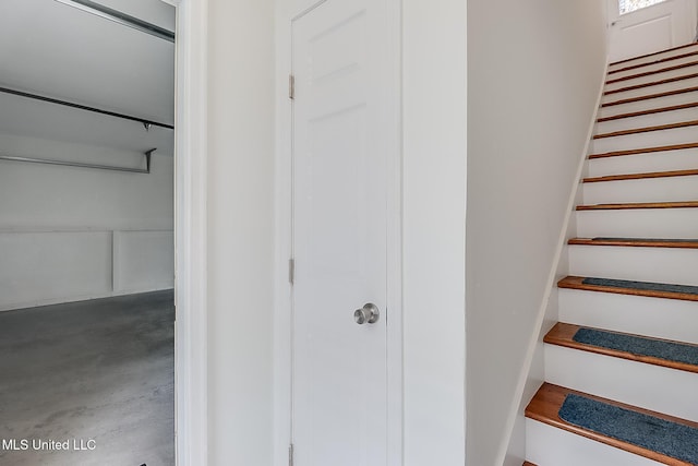 staircase with concrete flooring