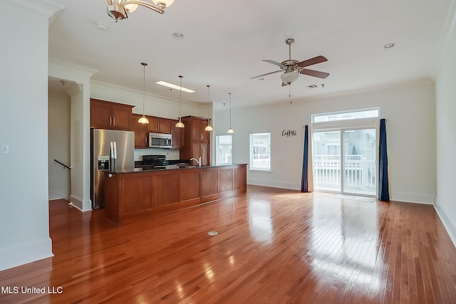 kitchen featuring hardwood / wood-style flooring, appliances with stainless steel finishes, and ornamental molding