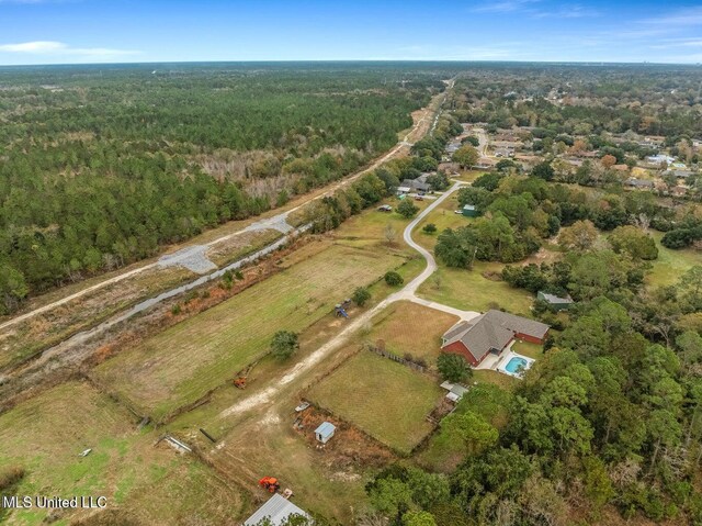 bird's eye view with a wooded view