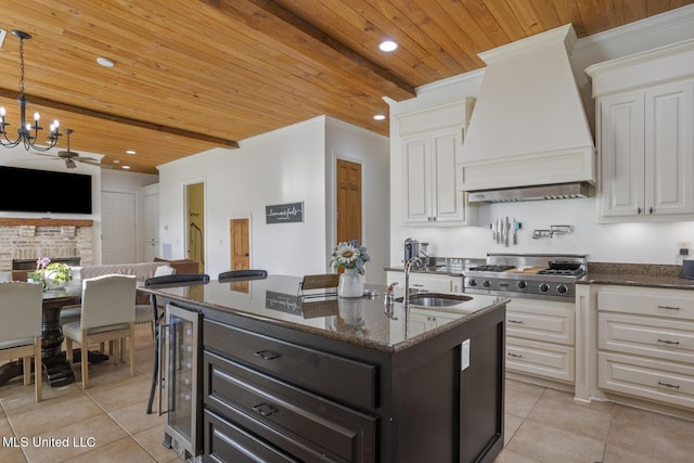 kitchen with a sink, premium range hood, wood ceiling, and light tile patterned flooring