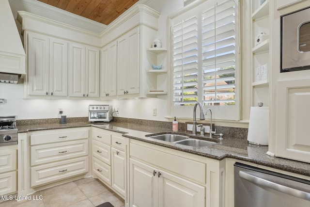 kitchen with stainless steel dishwasher, open shelves, custom exhaust hood, a sink, and dark stone countertops