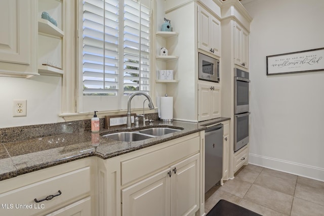 kitchen with a sink, light tile patterned floors, open shelves, and stainless steel appliances