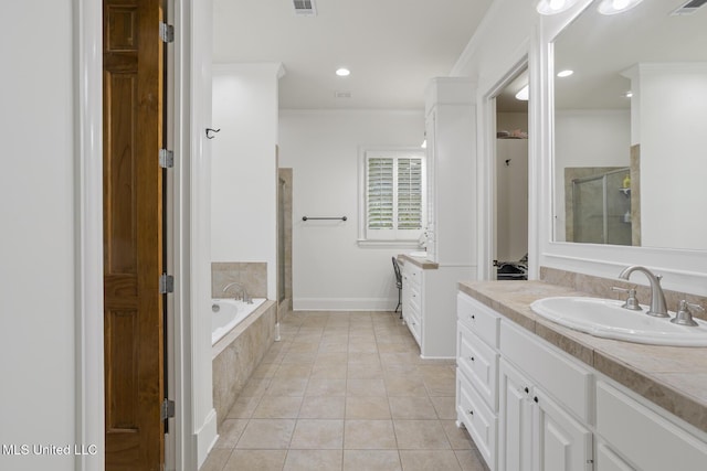 full bathroom with vanity, ornamental molding, a bath, tile patterned floors, and a shower stall