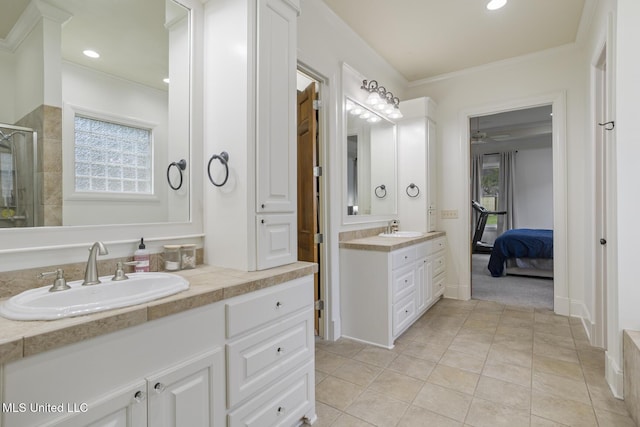 bathroom featuring a sink, ceiling fan, a stall shower, and two vanities