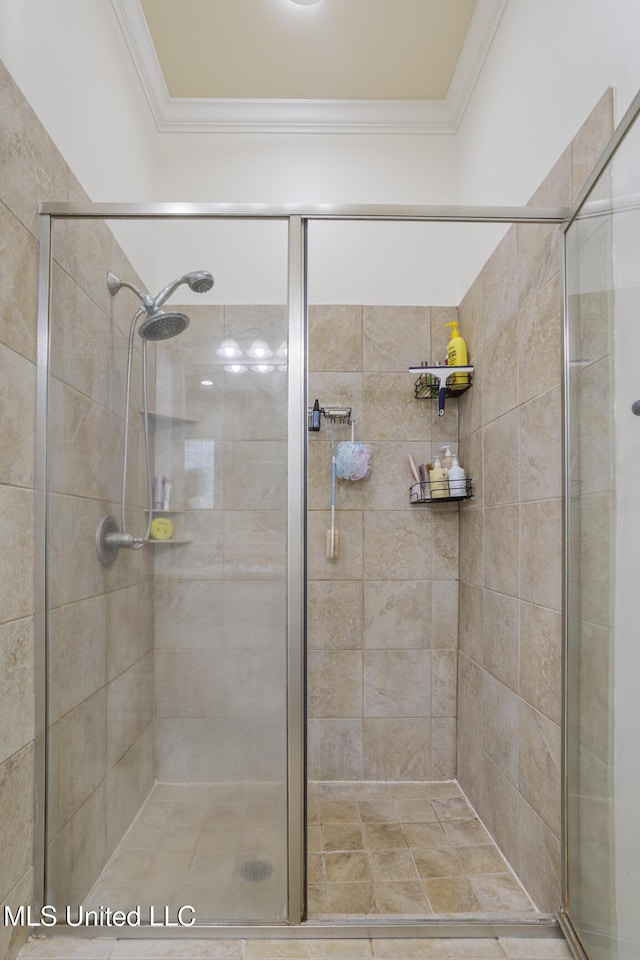 bathroom with ornamental molding and a shower stall