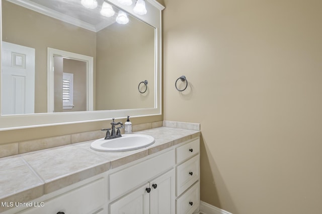 bathroom featuring crown molding and vanity