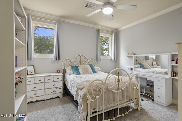 carpeted bedroom featuring crown molding, a ceiling fan, and visible vents