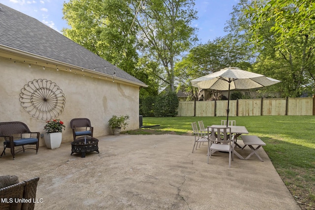 view of patio / terrace with fence, outdoor dining area, and an outdoor fire pit