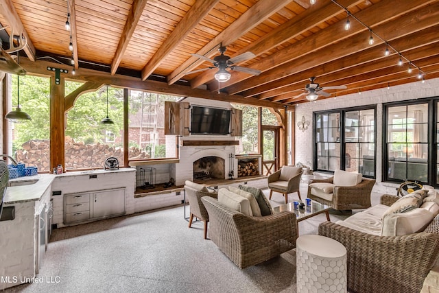 107 Chadwyck Ct, Madison, MS 39110 - living area with wood ceiling, plenty of natural light, beam ceiling, ceiling fan, and an outdoor fireplace