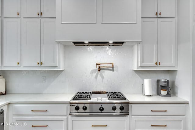 107 Chadwyck Ct, Madison, MS 39110 - kitchen with stainless steel gas stovetop, white cabinetry, and backsplash