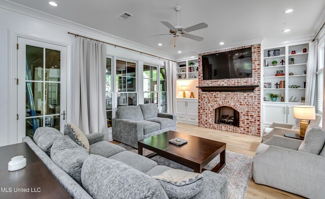 107 Chadwyck Ct, Madison, MS 39110 - living area featuring a ceiling fan, wood finished floors, recessed lighting, a brick fireplace, and crown molding