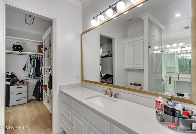 107 Chadwyck Ct, Madison, MS 39110 - full bathroom featuring a spacious closet, vanity, wood finished floors, an enclosed shower, and crown molding