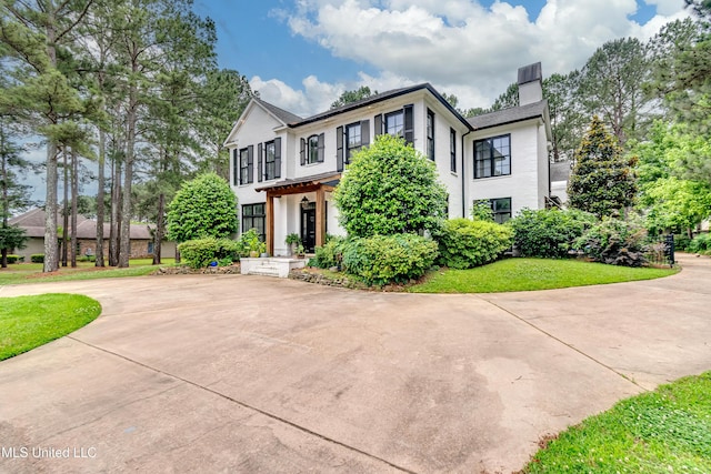 107 Chadwyck Ct, Madison, MS 39110 - view of front of property featuring curved driveway, a chimney, and stucco siding