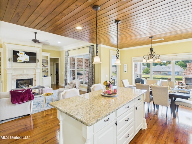 143 Charlton Dr, Madison, MS 39110 - kitchen featuring wood-type flooring, crown molding, wooden ceiling, decorative light fixtures, and white cabinetry