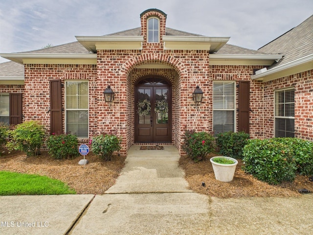 143 Charlton Dr, Madison, MS 39110 - property entrance with french doors, brick siding, and a shingled roof