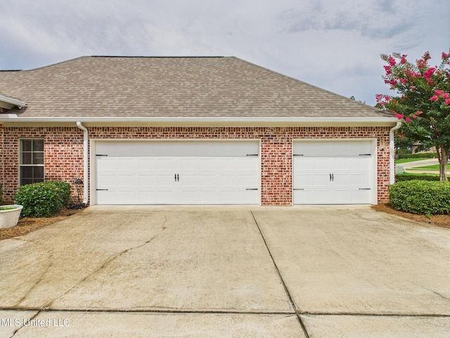 143 Charlton Dr, Madison, MS 39110 - view of property exterior featuring roof with shingles, concrete driveway, and a garage