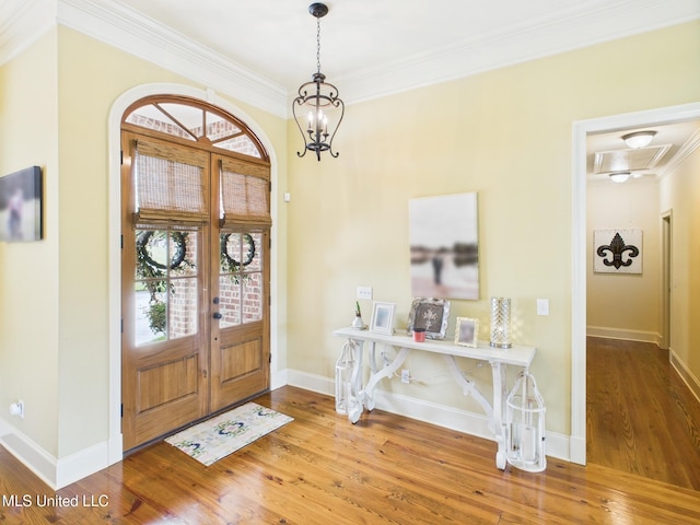 143 Charlton Dr, Madison, MS 39110 - foyer featuring wood finished floors, crown molding, french doors, and a chandelier