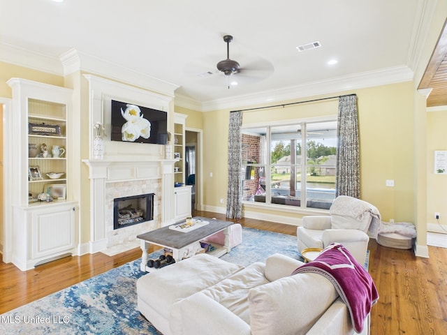 143 Charlton Dr, Madison, MS 39110 - living area featuring ornamental molding, a ceiling fan, wood finished floors, and a tiled fireplace