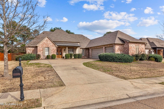 view of front facade featuring brick siding, a shingled roof, concrete driveway, an attached garage, and fence