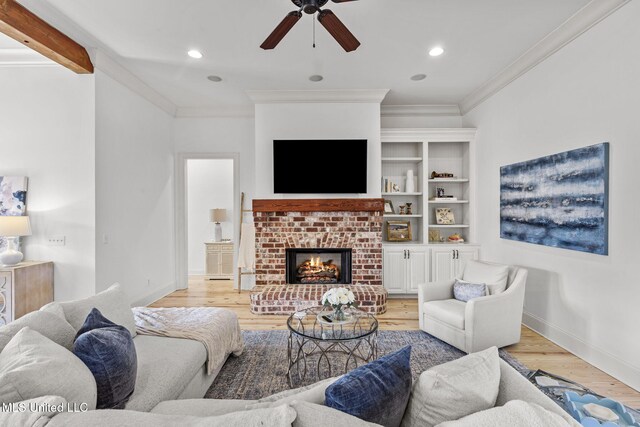 living area with ornamental molding, light wood-type flooring, a fireplace, and recessed lighting