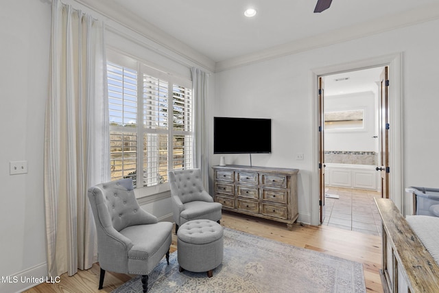 living area with a ceiling fan, recessed lighting, baseboards, and light wood finished floors