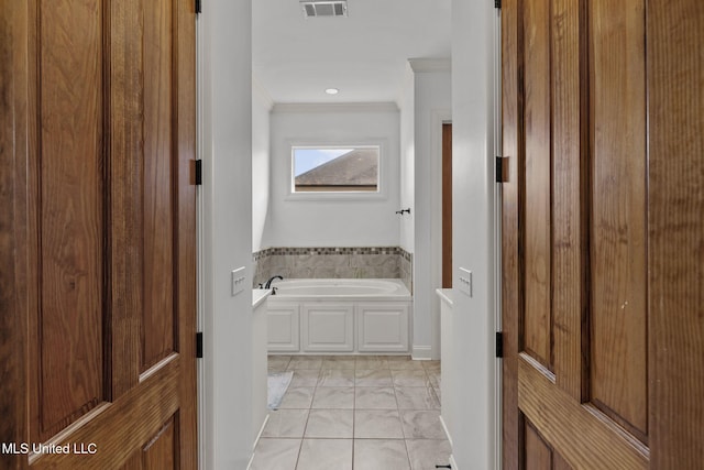 full bath featuring ornamental molding, visible vents, and a garden tub