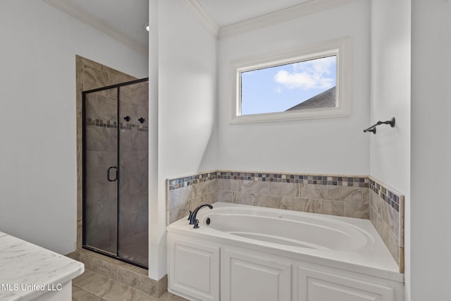 bathroom featuring a stall shower, a garden tub, and crown molding