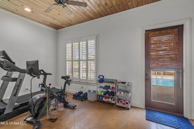 workout room with baseboards, wood ceiling, and crown molding