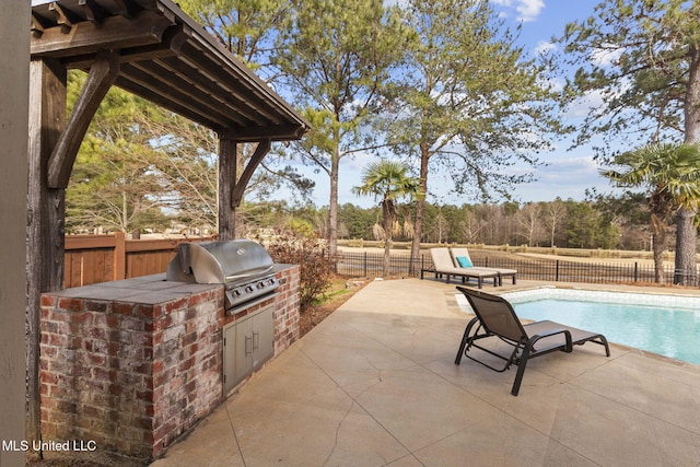 view of patio / terrace with area for grilling, grilling area, a fenced backyard, and a fenced in pool