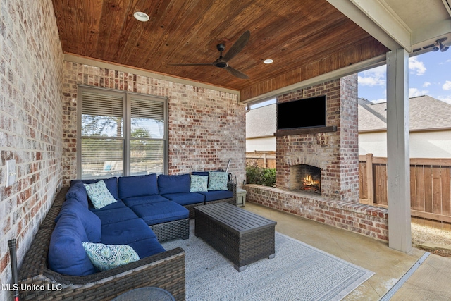 view of patio / terrace featuring an outdoor living space with a fireplace, fence, and ceiling fan