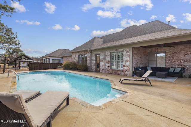 view of pool with a ceiling fan, a fenced in pool, a patio, a gazebo, and outdoor lounge area