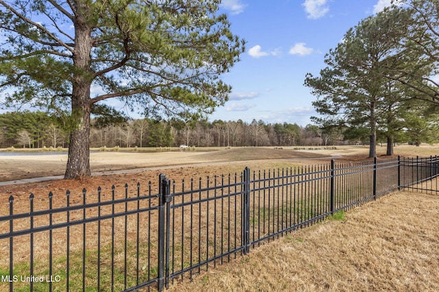 view of yard featuring a rural view and fence