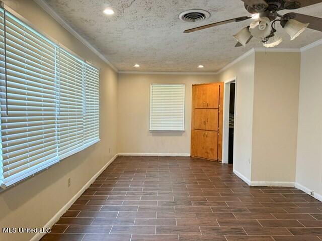 305 Longview St, Vicksburg, MS 39180 - empty room with a ceiling fan, crown molding, baseboards, visible vents, and recessed lighting
