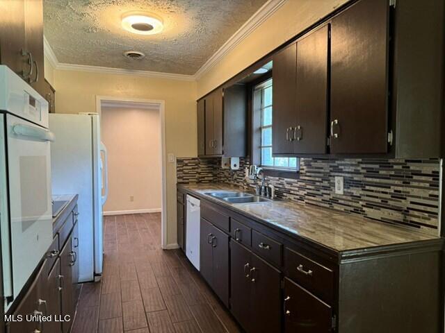 305 Longview St, Vicksburg, MS 39180 - kitchen with a textured ceiling, a sink, backsplash, white appliances, and dark wood-type flooring