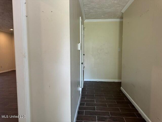305 Longview St, Vicksburg, MS 39180 - hall featuring baseboards, ornamental molding, a textured ceiling, and wood tiled floor