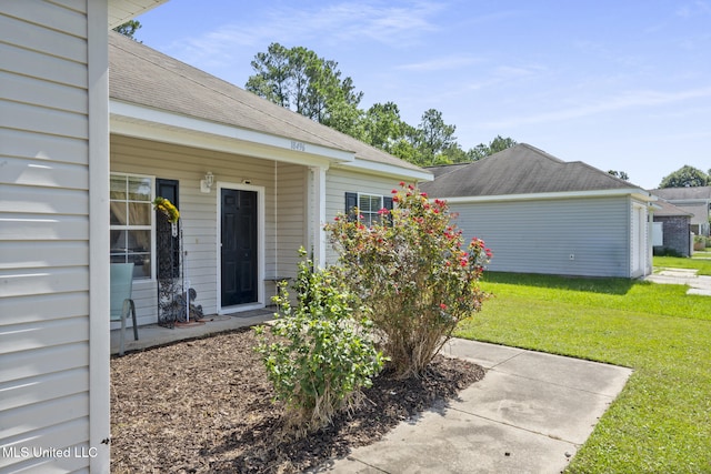 18496 Devin Ct, Gulfport, MS 39503 - doorway to property featuring a yard and a shingled roof