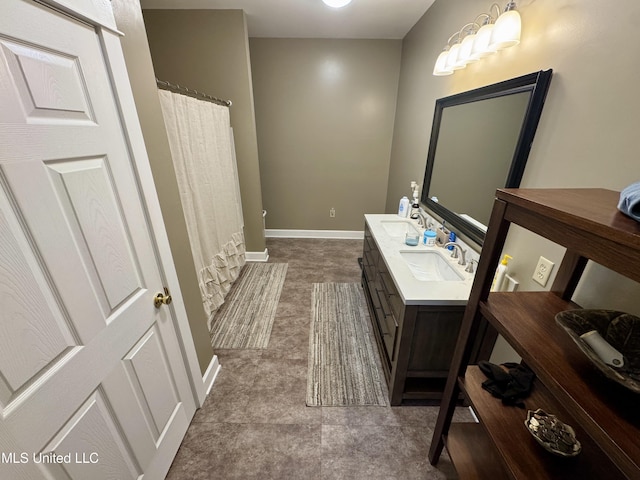 590 Eubanks Rd, Alligator, MS 38720 - bathroom featuring double vanity, baseboards, and curtained shower