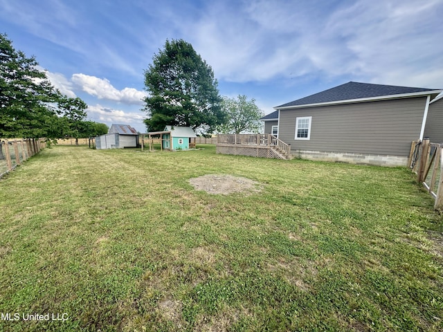 590 Eubanks Rd, Alligator, MS 38720 - view of yard with a storage unit, a deck, and an outbuilding