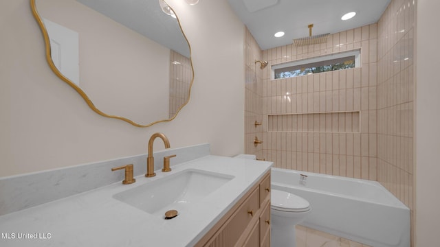 full bathroom featuring toilet, vanity, and tiled shower / bath