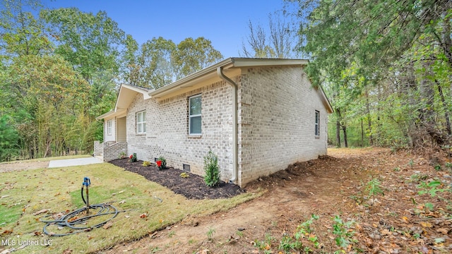 view of side of property with a yard and a patio area