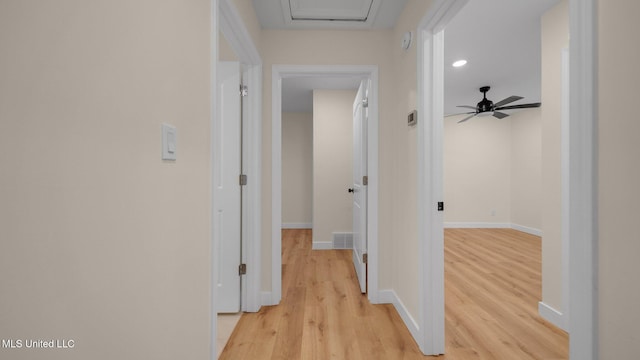 corridor with light hardwood / wood-style floors