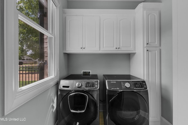 clothes washing area with cabinets and independent washer and dryer