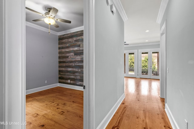 hallway featuring ornamental molding and light wood-type flooring