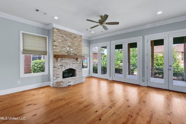 unfurnished living room with crown molding, a fireplace, light hardwood / wood-style floors, and ceiling fan