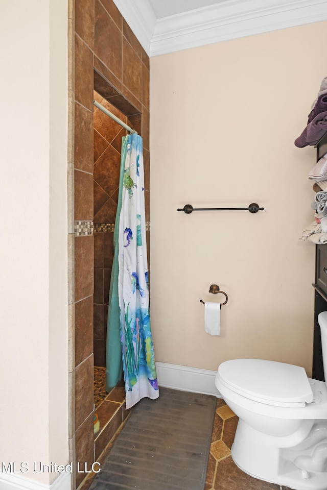 bathroom featuring walk in shower, crown molding, and toilet